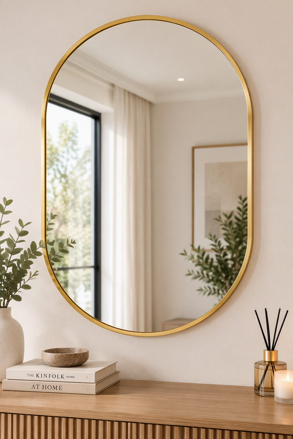 Gold capsule wall mirror styled above a console table